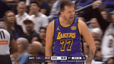 A Basketball Player For The Lakers Is Standing In Front Of A Crowd GIF
