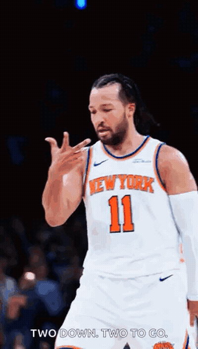 A Basketball Player For The New York Knicks Is Giving A Thumbs Up Sign . GIF