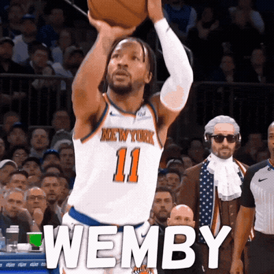 A Basketball Player For The New York Knicks Shoots A Ball GIF