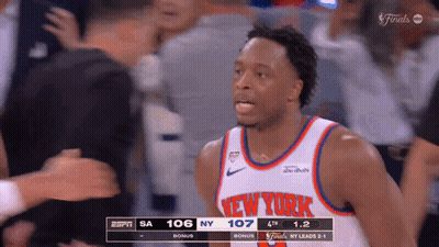 A Basketball Player For The New York Knicks Stands In Front Of A Crowd During A Game GIF