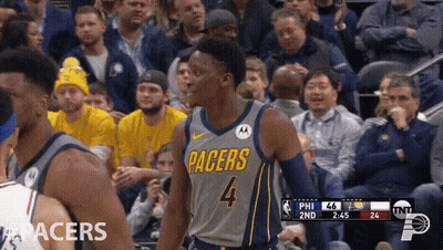 A Basketball Player For The Pacers Is Standing In Front Of A Crowd GIF