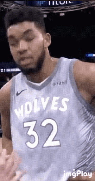 A Basketball Player For The Wolves Is Wearing A Blue Jersey With The Number 32 On It . GIF