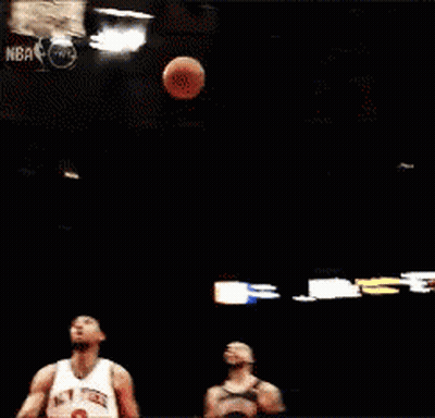 A Basketball Player Going For A Dunk In Front Of A Sign That Says 15 GIF