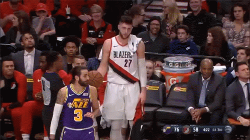 A Basketball Player In A Blazers Jersey Stands Next To Another Player In A Jazz Jersey GIF