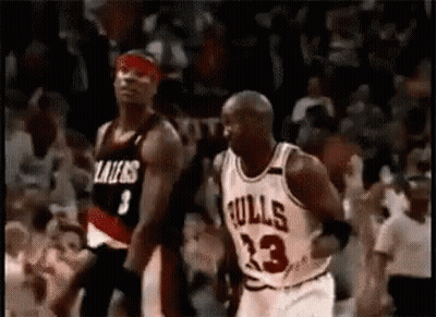 A Basketball Player In A Bulls Jersey Is Dribbling A Basketball While Another Player In A Lakers Jersey Watches . GIF