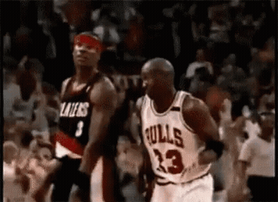A Basketball Player In A Bulls Jersey Is Dribbling A Basketball While Another Player Tries To Stop Him . GIF