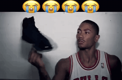 A Basketball Player In A Bulls Jersey Is Holding A Shoe GIF