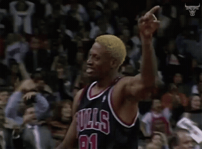 A Basketball Player In A Bulls Jersey Is Pointing At The Crowd . GIF