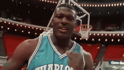 A Basketball Player In A Charlotte Hornets Jersey Is Standing In Front Of A Basketball Hoop . GIF
