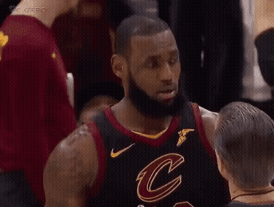 A Basketball Player In A Cleveland Cavaliers Jersey Is Talking To Another Player . GIF