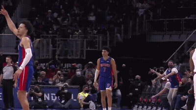 A Basketball Player In A Detroit Jersey Is Standing On The Court . GIF