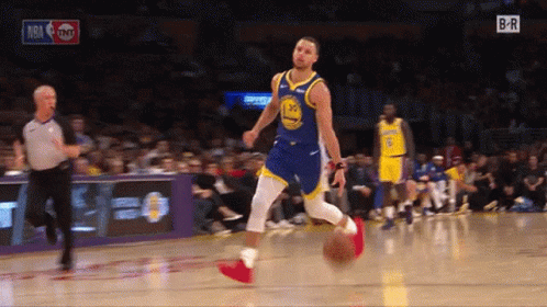 A Basketball Player In A Golden State Warriors Uniform Is Dribbling A Ball GIF