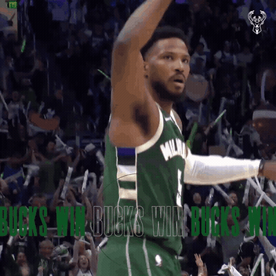 A Basketball Player In A Green Milwaukee Jersey Celebrates With Fans GIF