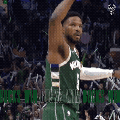 A Basketball Player In A Green Milwaukee Jersey Celebrates With Fans GIF