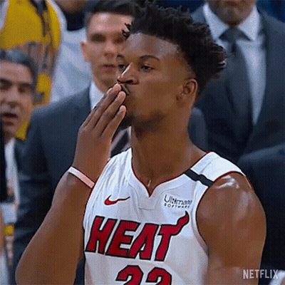 A Basketball Player In A Heat Jersey Is Blowing A Kiss . GIF