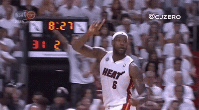 A Basketball Player In A Heat Jersey Is Giving A Thumbs Up In Front Of A Crowd Of People . GIF