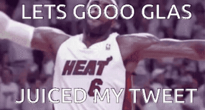 A Basketball Player In A Heat Jersey With His Arms In The Air GIF