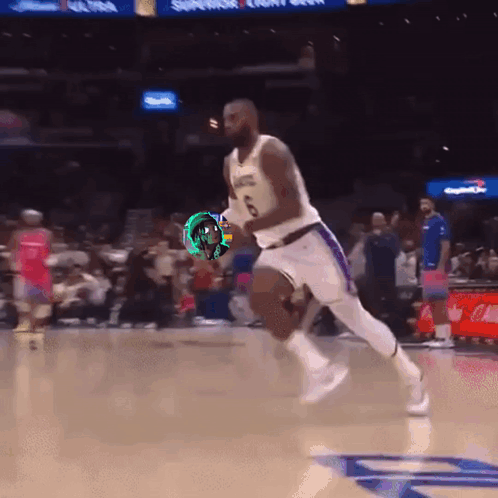 A Basketball Player In A Lakers Jersey Is Running On The Court GIF