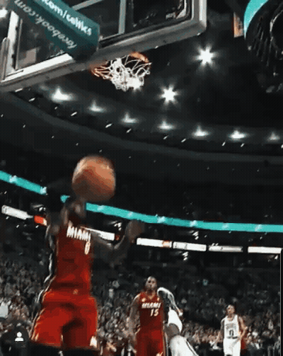 A Basketball Player In A Miami Jersey Is Going For A Dunk GIF