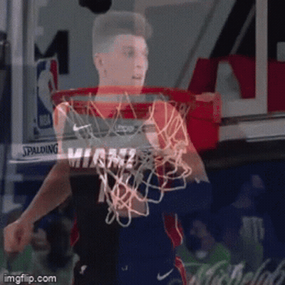 A Basketball Player In A Miami Jersey Is Holding A Basketball Net GIF
