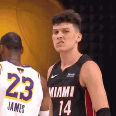 A Basketball Player In A Miami Jersey Is Standing Next To Another Player In A White Jersey . GIF