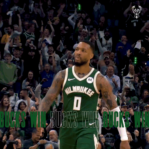A Basketball Player In A Milwaukee Jersey Stands In Front Of A Crowd GIF