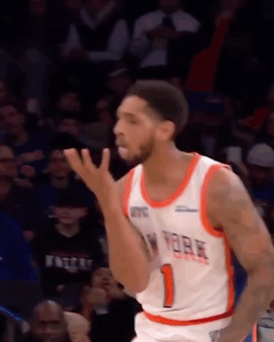 A Basketball Player In A New York Knicks Jersey Is Standing On The Court . GIF