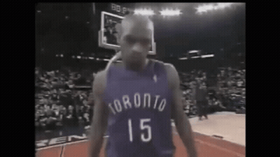 A Basketball Player In A Purple Jersey With The Number 15 On It Is Standing On A Court . GIF