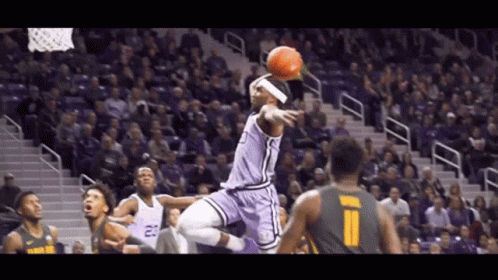 A Basketball Player In A Purple Uniform With The Number 23 On His Jersey GIF