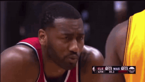 A Basketball Player In A Red And White Jersey Is Looking At Another Player In A Yellow Jersey GIF