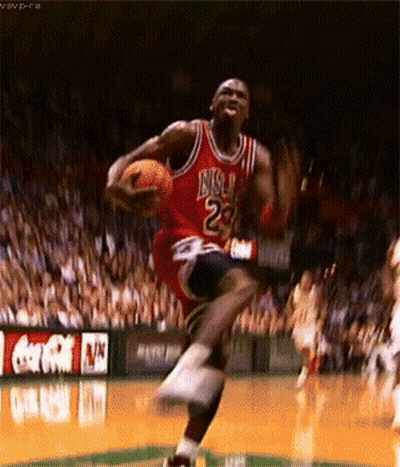 A Basketball Player In A Red Jersey With The Number 23 On It Is Jumping In The Air While Holding A Basketball . GIF