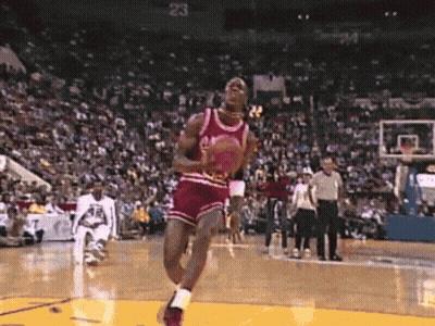 A Basketball Player In A Red Jersey With The Number 23 On The Back Jumps In The Air GIF
