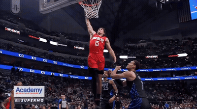 A Basketball Player In A Red Rockets Jersey Dribbles The Ball GIF