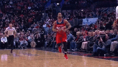A Basketball Player In A Red Uniform Is Dribbling The Ball GIF