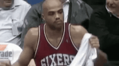 A Basketball Player In A Sixers Jersey Is Taking Off His Shirt . GIF