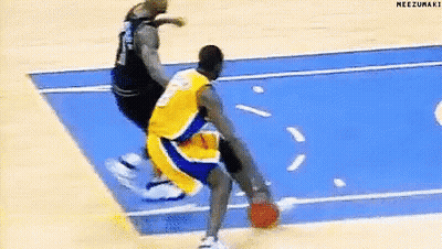 A Basketball Player In A Yellow Jersey Is Dribbling The Ball On A Blue Court . GIF