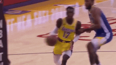 A Basketball Player In A Yellow Jersey Is Dribbling The Ball While Another Player In A Blue Jersey Tries To Stop Him . GIF