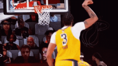 A Basketball Player In A Yellow Jersey With The Number 3 On It Is Jumping In The Air . GIF