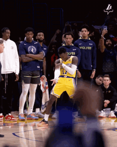 A Basketball Player In A Yellow Jersey With The Word Wolves On The Front GIF