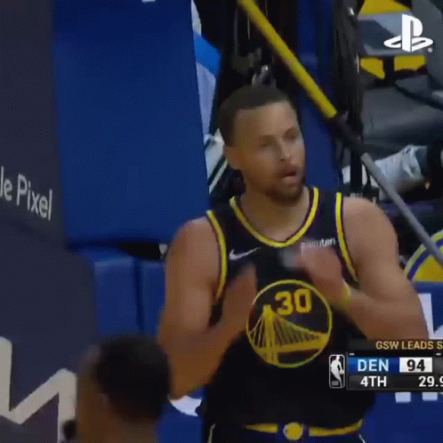A Basketball Player Is Clapping His Hands During A Game . GIF