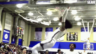 A Basketball Player Is Doing A Dunk On A Basketball Court While A Crowd Watches . GIF