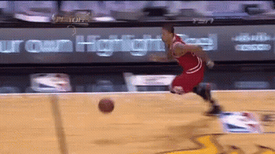 A Basketball Player Is Dribbling A Ball On A Court With A Sign That Says Iron Heights In The Background GIF
