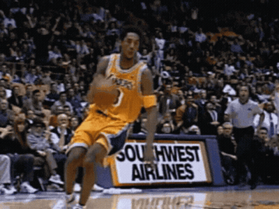 A Basketball Player Is Dribbling A Basketball In Front Of A Southwest Airlines Sign GIF