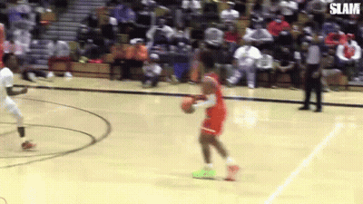 A Basketball Player Is Dribbling A Basketball On A Court While Another Player Tries To Stop Him . GIF