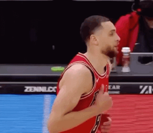 A Basketball Player Is Giving A Thumbs Up During A Game While Wearing A Red Jersey . GIF
