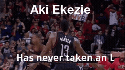 A Basketball Player Is Hugging Another Player On The Court While A Crowd Watches . GIF