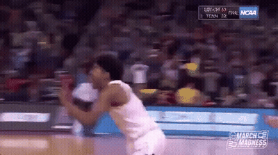 A Basketball Player Is Jumping In The Air During A Game Sponsored By Ncaa GIF