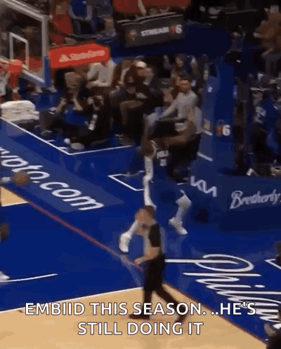 A Basketball Player Is Jumping In The Air During A Game With The Caption " Embiid This Season He 'S Still Doing It GIF