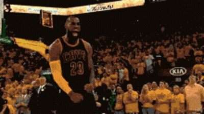 A Basketball Player Is Jumping In The Air In Front Of A Crowd While Wearing A Number 23 Jersey . GIF