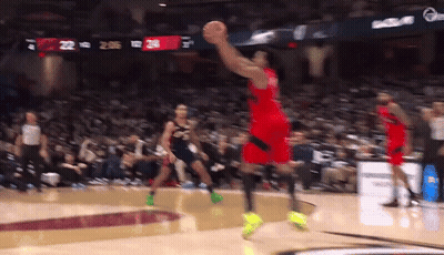 A Basketball Player Is Jumping In The Air To Catch A Basketball GIF